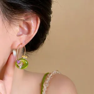 Summer fresh green resin circular hoop earrings with stone beads shown on an Asian model