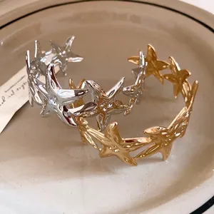 Elegant minimalist metallic starfish open bangles in gold and silver finish for women.