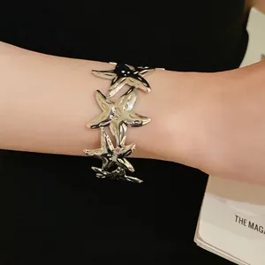 Elegant silver metallic starfish open cuff bracelet for women, stylish ocean-themed accessory