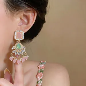 Macro detail showing the intricate design of vintage resin tassel earrings with pink beads