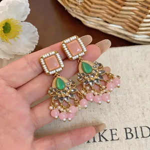 Elegant vintage gold earrings with pink resin squares and green drop stone detail