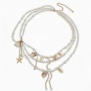 Multi-layer pearl waist chain with shells and starfish charms for ocean vacation style.