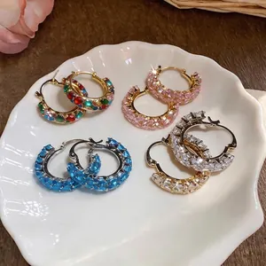 Elegant wheat ear zircon hoop earrings in assorted colors displayed on a white shell dish