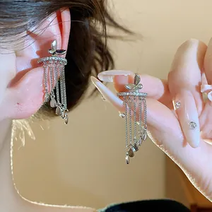 Macro detail of elegant silver butterfly tassel clip-on earrings with sparkling zircon