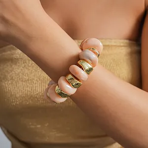Close-up of retro irregular geometric acrylic and gold beaded elastic bracelet on arm