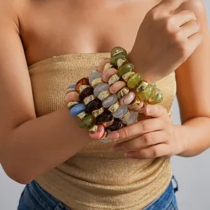Close-up of colorful acrylic geometric beaded elastic bracelets on wrist
