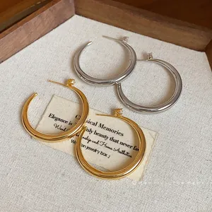 Minimalist 18k gold plated and silver hoop earrings with sparkling zircon accents.