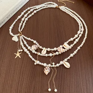 Detailed view of multilayer pearl waist chain featuring exquisite shell and starfish charms