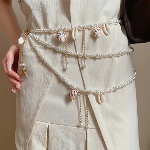 Exquisite detail of layered pearl waist chain featuring natural shell and starfish charms
