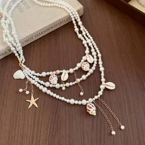 Detailed view of ocean-themed pearl waist chain with real conch and shell pendants