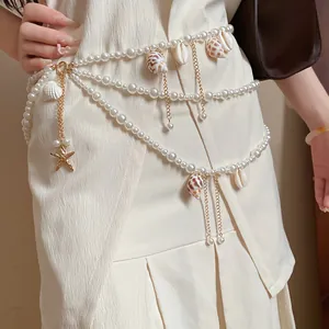 Detail showing the multi-layered pearl waist chain with shells and starfish charms.