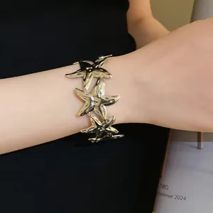Close-up of the elegant metallic starfish cuff bracelet showing intricate design details