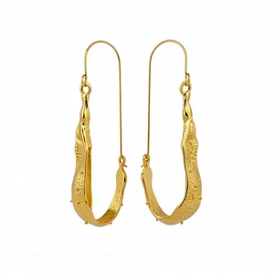 Minimalist gold U-shaped earrings with unique textured surface and stud accents.