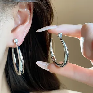 Close-up of elegant silver-toned hoop earrings with sparkling zirconia detail
