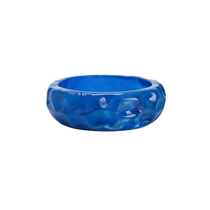 Chunky vibrant blue resin bangle bracelet with unique rippled texture and dimpled design.