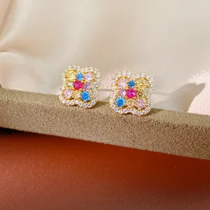 Detailed view of 14k gold plated clover flower stud earrings with multi-color zircon