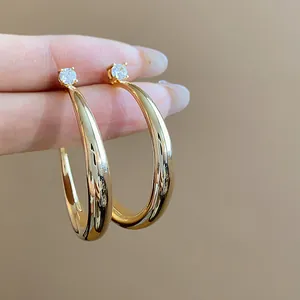 Detail view of 18k gold plated hoop earrings with sparkling white zirconia stones