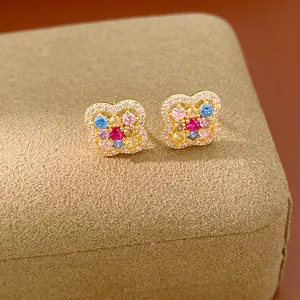 Macro detail of 14k gold plated flower stud earrings featuring vibrant multi-colored zircons