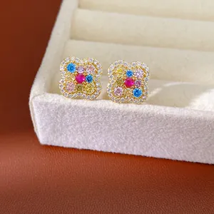 Detailed view of 14k gold plated clover earrings with colorful zircon stones in a velvet box