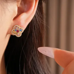 Detailed close-up of a 14k gold-plated clover earring with colorful zircons