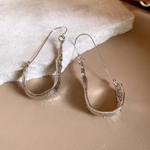 Elegant minimalist silver U-shaped pendant ear hooks with irregular molten texture
