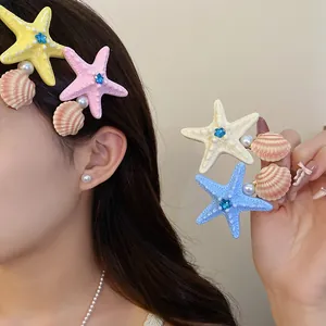 Detail shot of colorful starfish and seashell hair clips for summer vacation hairstyles.