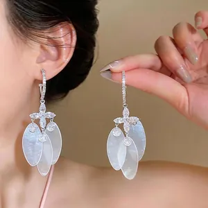 Elegant silver needle earrings with marquise zircon and dangling white shell petals