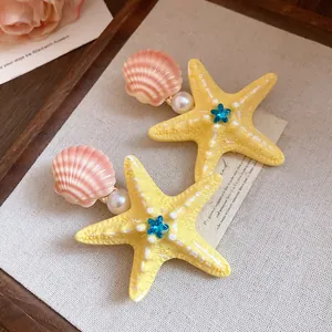 Close-up of colorful starfish and shell hair clips with pearl and blue star gems