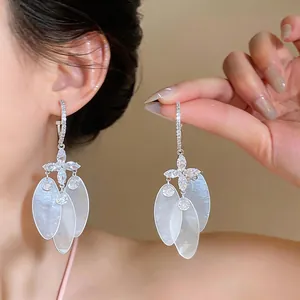 Elegant silver needle dangle earrings with zircon cross and oval shell pendants