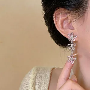 Elegant silver hollow flower drop earrings for non-pierced ears in minimalist style