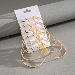 Macro view of a six-piece set of stylish gold hoop earrings on a white display card