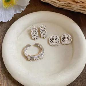 Close-up detail of exquisite hollow zircon jewelry set featuring pearls on display plate