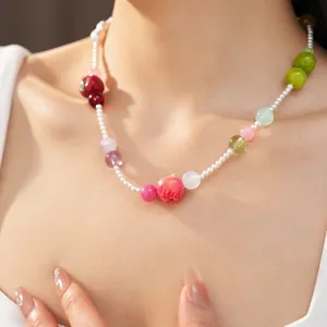 Close-up of a colorful resin apple necklace on a woman for a sweet summer vacation look