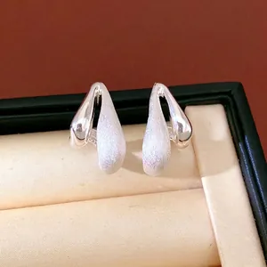 Elegant minimalist silver water drop stud earrings with a textured brushed finish for women