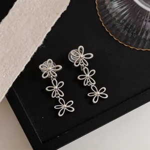 Silver-colored hollow triple flower clip-on earrings with elegant textured finish