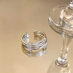Macro view of silver-plated multi-layer open ring with sparkling white zircons