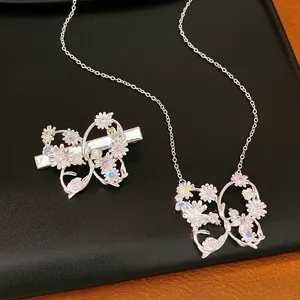 Detailed view of elegant silver butterfly hair clip and necklace set with colorful zircons