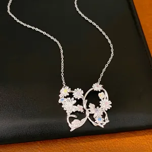 Detail shot of silver butterfly pendant featuring colorful zircon stones and floral designs