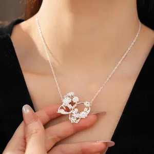 Detailed view of silver butterfly necklace featuring intricate zircon flower accents