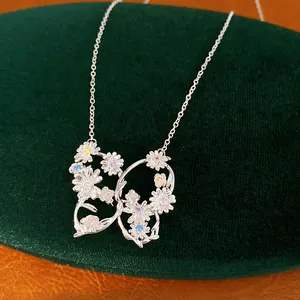 Close-up of silver butterfly necklace with colorful zircon flower details and fine chain