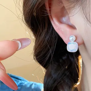 Detailed view of elegant pearl stud earring featuring a shimmering iridescent stone