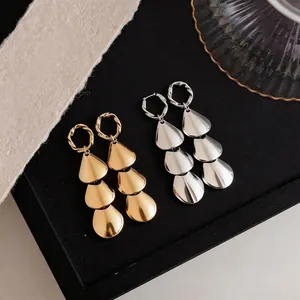 Minimalist metallic triple-tiered teardrop drop earrings in gold and silver finishes