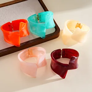 Close-up of colorful irregular geometric resin bangles in marbled vibrant shades