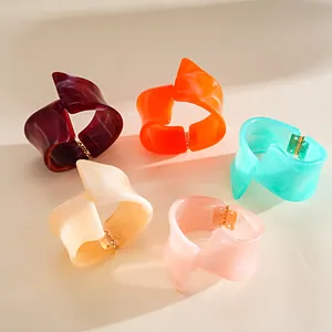 Close-up of irregular geometric resin bracelets with marble texture in five colors