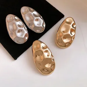 Elegant vintage hammered metal oval stud earrings in polished gold and silver finishes