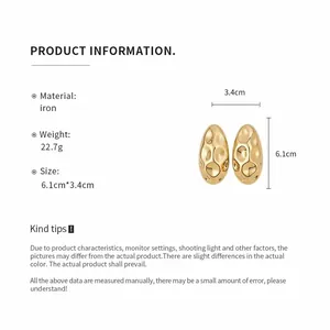 Detail of vintage golden oval metal earrings with material and size parameters