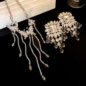 Detail view of sparkly rhinestone butterfly tassel necklace and crystal earrings set