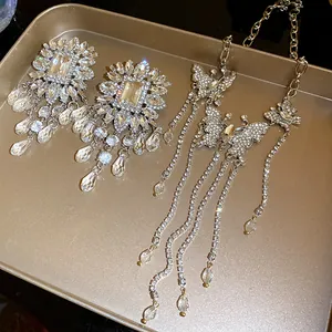 Stunning detail of heavy industry rhinestone butterfly tassel necklace and earrings set.