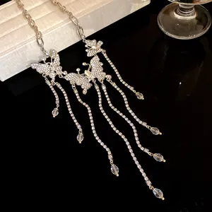 Elegant rhinestone butterfly tassel necklace with crystal charms for evening parties.