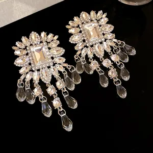 Close-up of elegant chandelier earrings with sparkling rhinestones and teardrop dangles